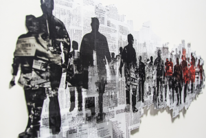 cutouts of newspaper showing world news and silhouette of people